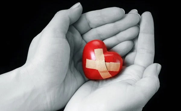 Hands with broken heart