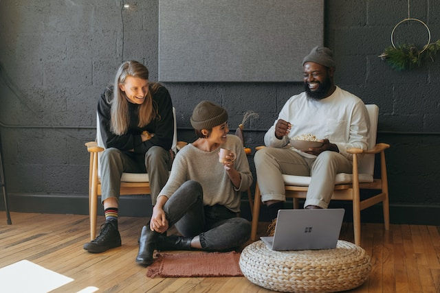 three coworkers sitting together laughing