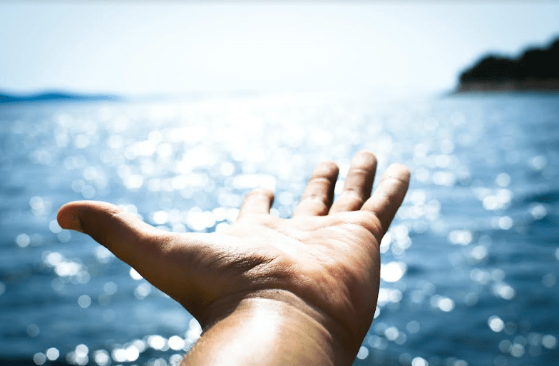 A hand at the sea.