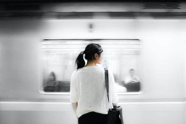 Woman's back with bag.