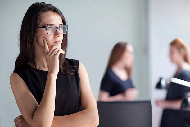 Young woman thinking in business office.
