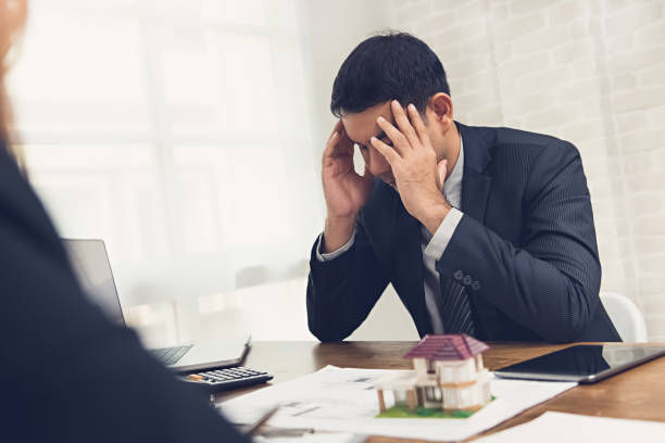 businessman getting stressed about real estate