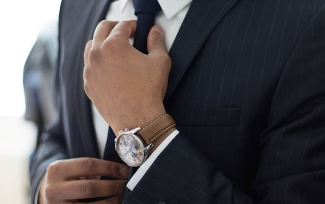 man wearing watch with black suit