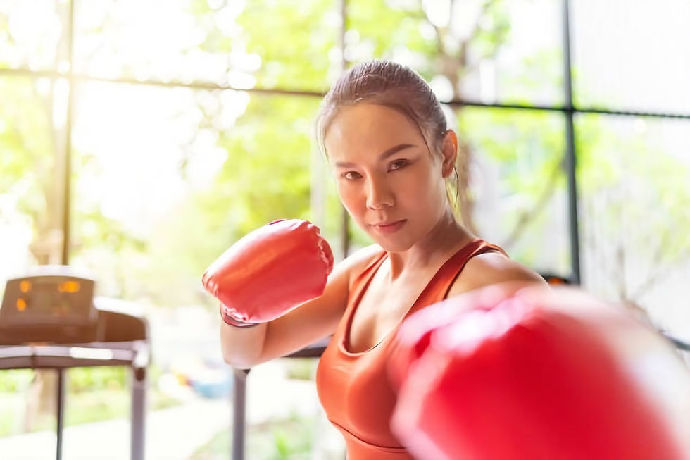 Woman engaged in boxing training at an indoor fitness gym