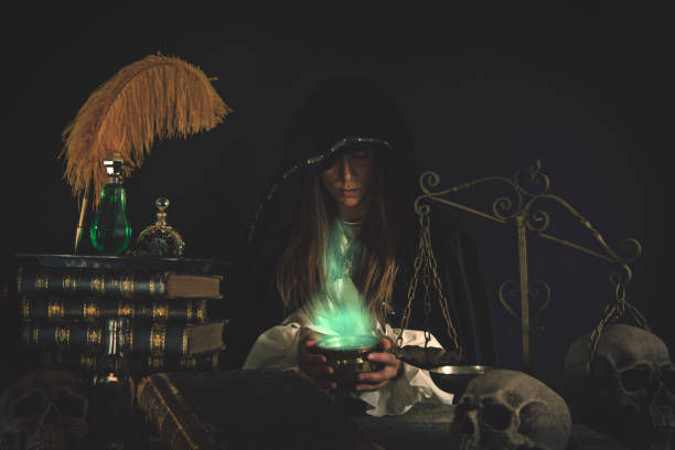 Female Wizard at table with Magical Items