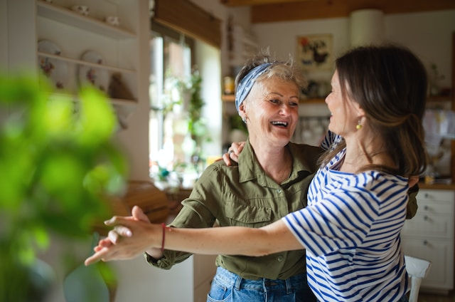 Happy senior mother having fun with adult daughter