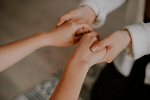 Two women holding hands
