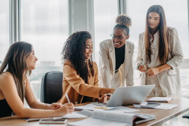 A group of women of diverse ages and backgrounds engaged in a brainstorming session.