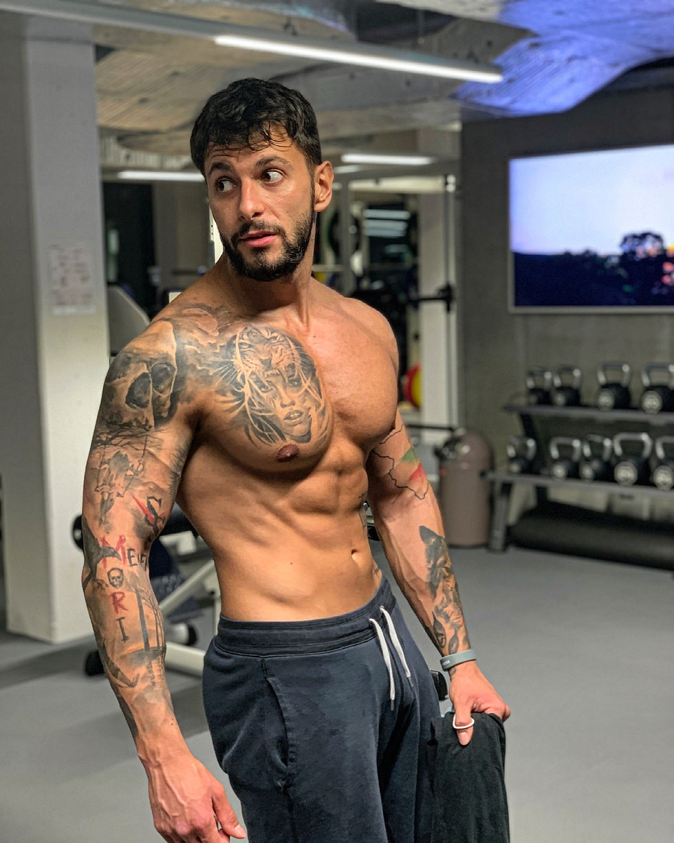 A guy holding a weigh in a gym