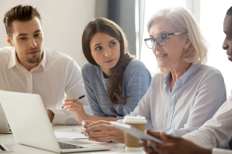 Four people in a room having a meeting.