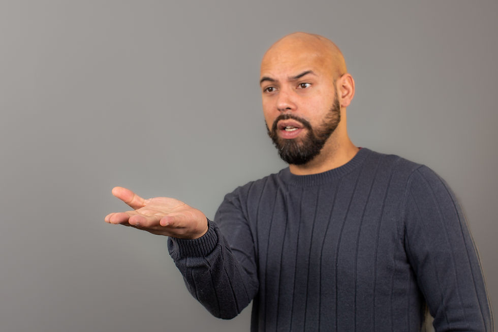 Man in a gray sweater with his palm open.