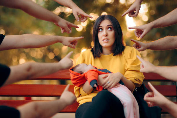 Fingers pointed at mom being criticized by society at the park.