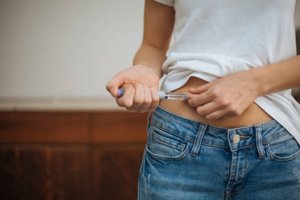 Woman doing insulin injection.