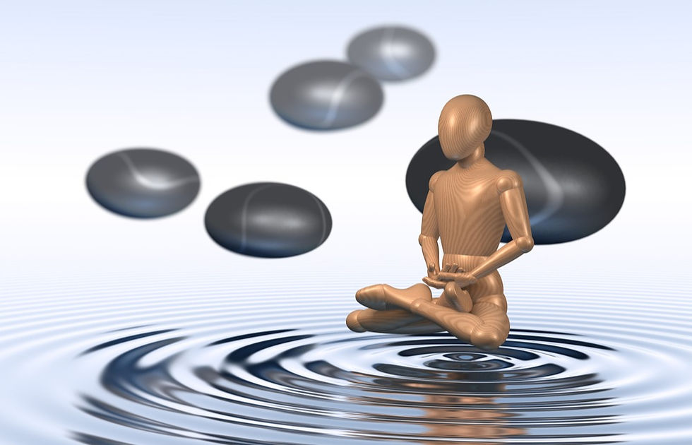 gold human figure meditating on body of water.