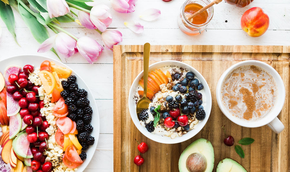 berries and veggies on white bowl and a coffee, flower on table.