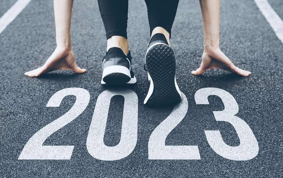 woman starting at 2023 mark sign on pavement.