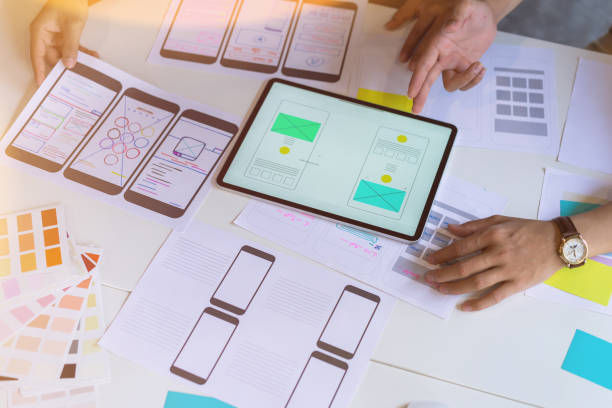 designer hands sketching of screens for mobile web design.