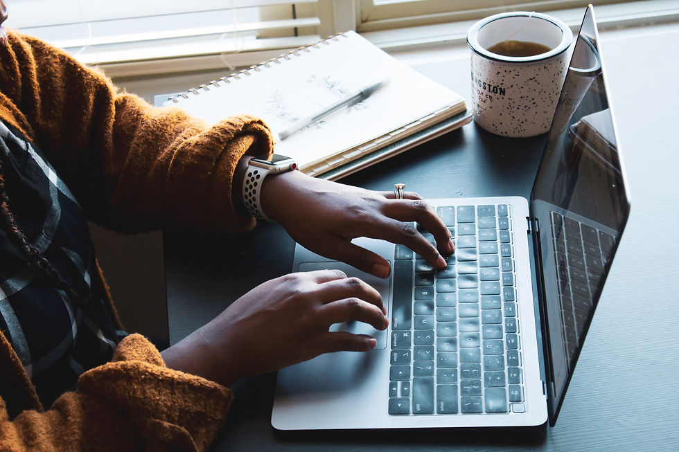 woman using a laptop at home while having coffee