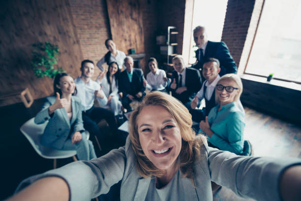 Group photo inside the office with company staff showing thumbs up. 