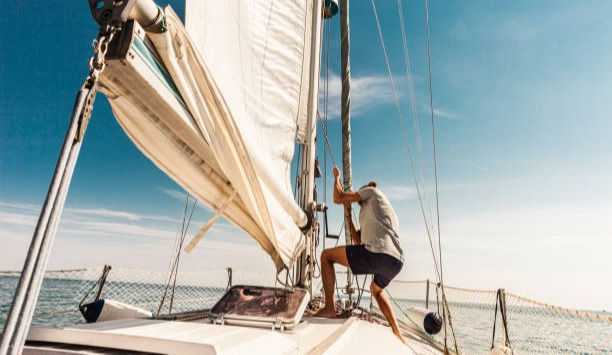 Man sailing and fishing during summer. 