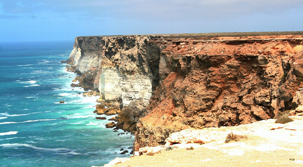 A beautiful photo of blue sea and a cliff.
