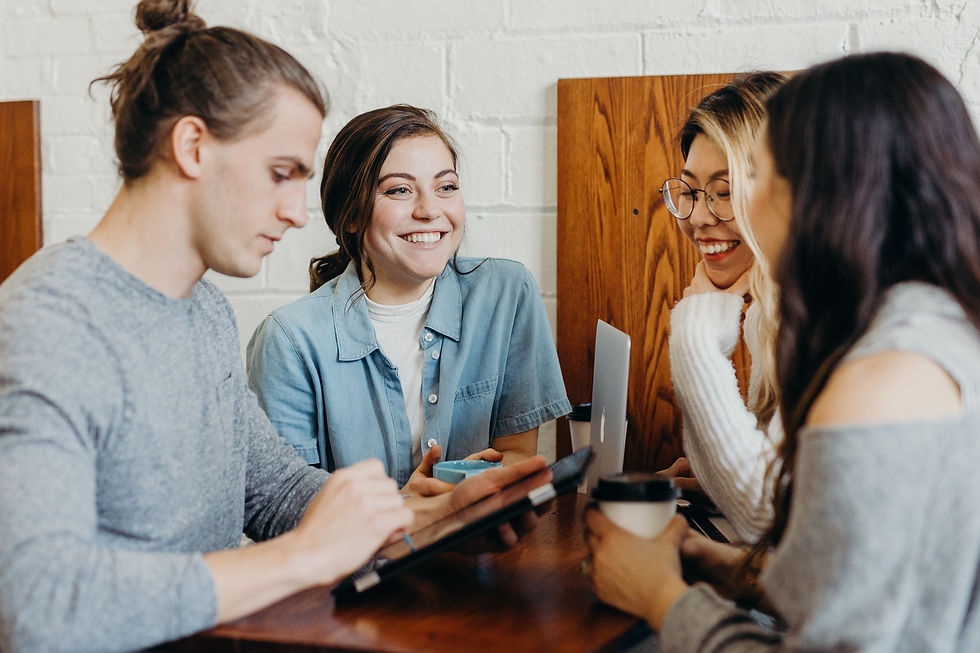 Group of young people having fun while working at a coffee shop. 