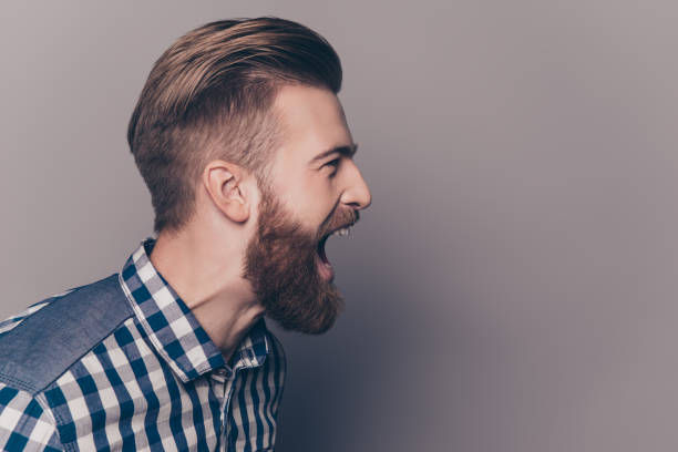 portrait unhappy furious businessman open mouth and shouting