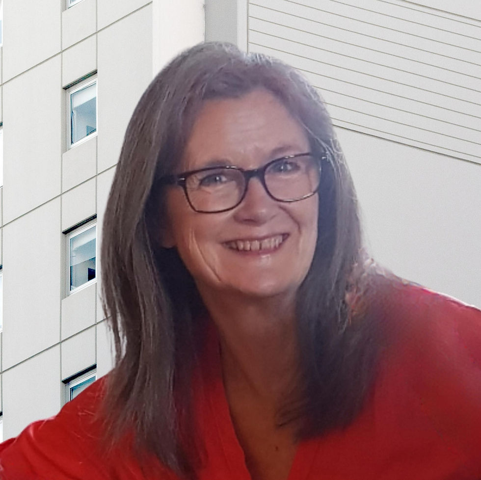 Shot of a woman smiling next to a building.