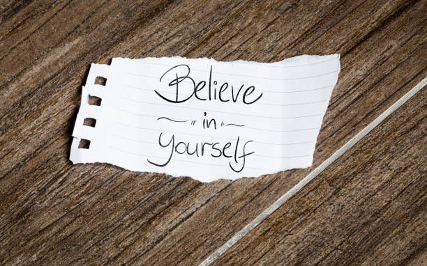 Believe in Yourself written on piece of paper. 