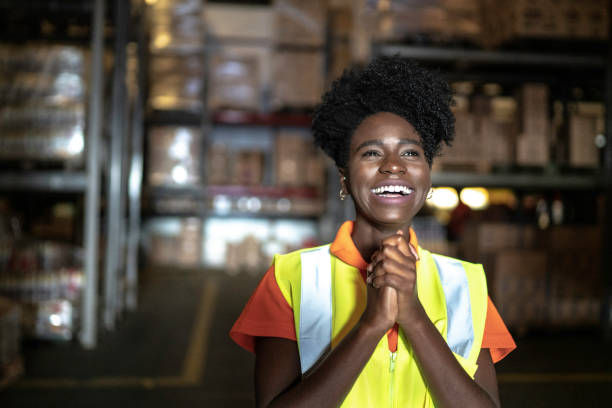 Grateful young woman worker at warehouse.
