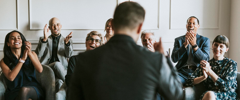 group of business people clapping for success one man speaking in front of them