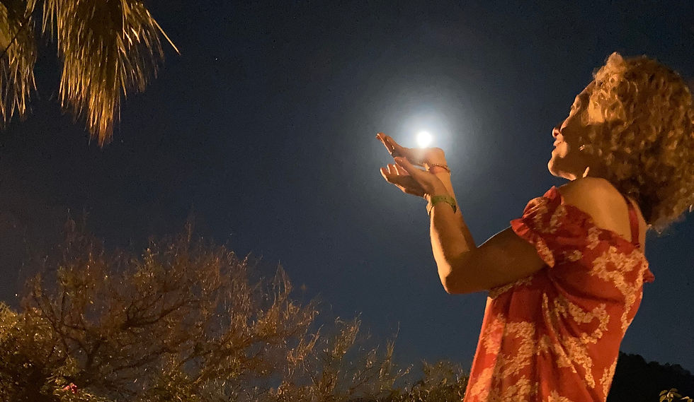 woman doing a picture trick, holding the moon.