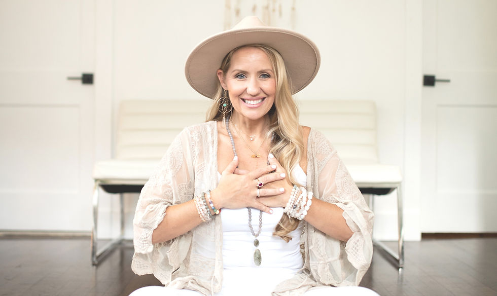 Woman in white with hat sitting on floor, feeling love with her self.
