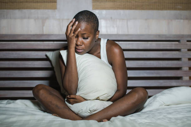 Young sad and depressed woman in bed sleepless late.