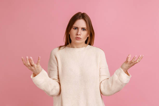 Woman raise hands to the sides and don't know right answer, negative human emotions