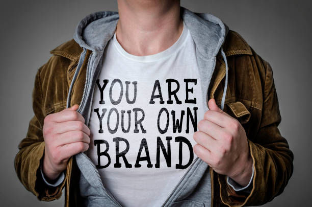 Man showing You Are Your Own Brand tittle on t-shirt. 