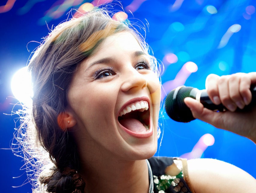 Young lady singing out loud with joy.