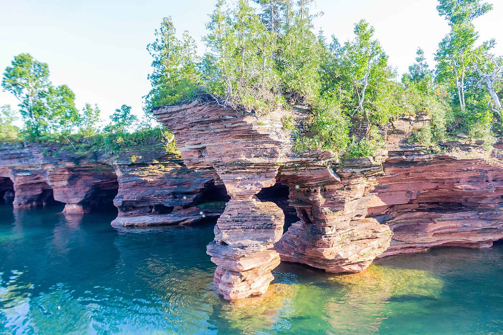 beautiful rock form standing on body of water