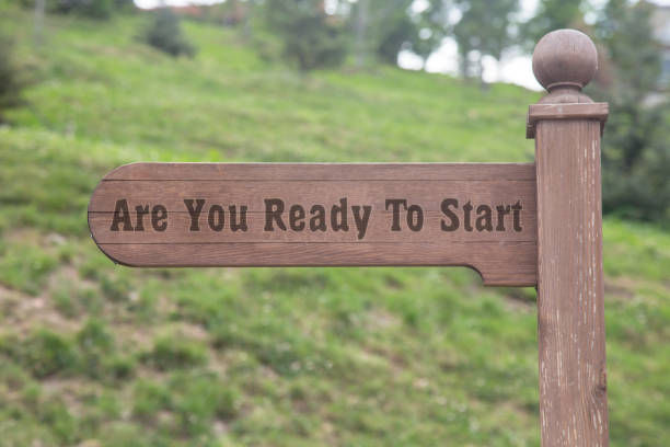 are you ready to start text wooden sign with a forest background. 