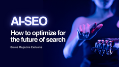 A woman reaching toward a robotic hand, symbolizing human and AI collaboration, with the title “AI SEO, How to optimize for the future of search” on a dark blue cover. Brainz Magazine Exclusive AI SEO guide by Brainz Magazine.