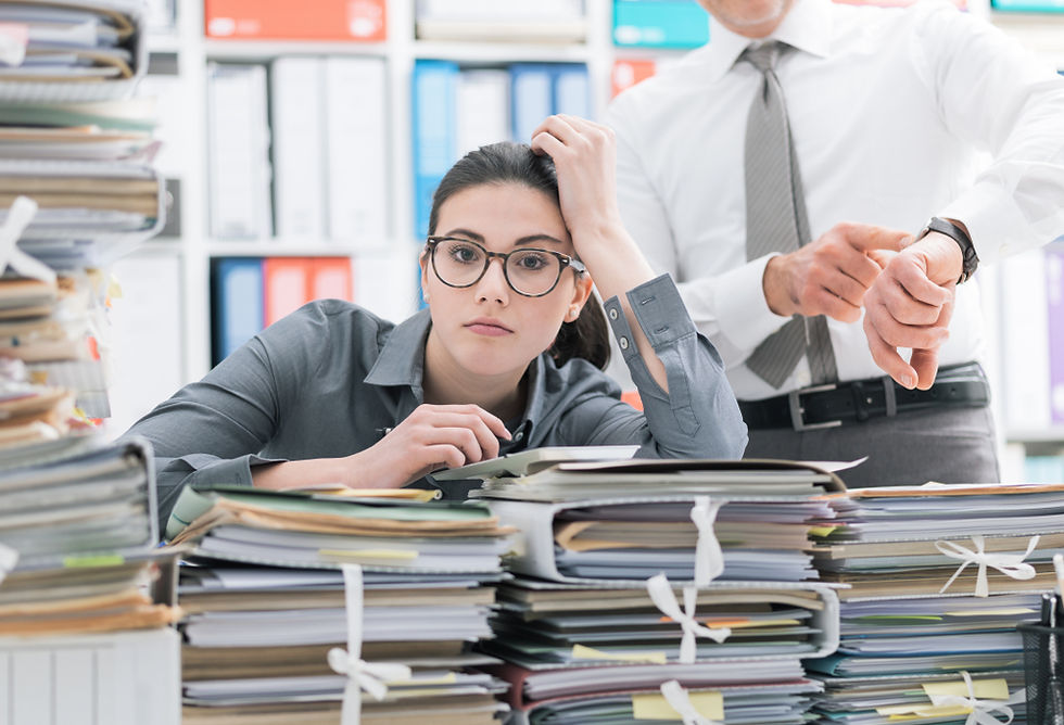 stress woman in eye glasses at the office with pile of paper works