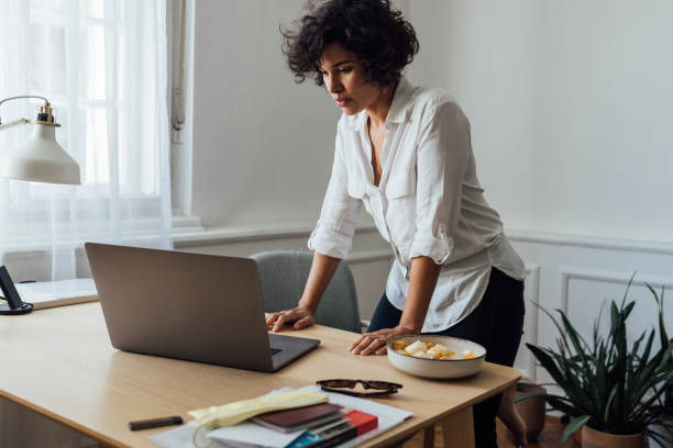 A good-looking female being busy in her office.