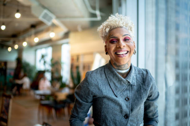 Portrait of a happy business woman in piercing and tattoos.