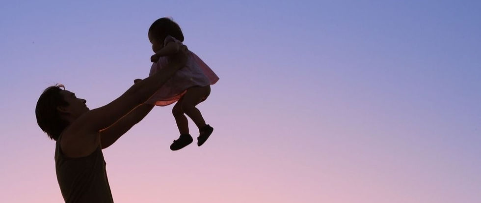Dad holding up his daughter in the air