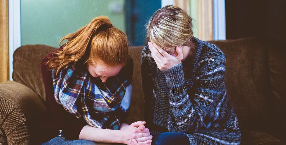 Two women dealing with grief on the sofa