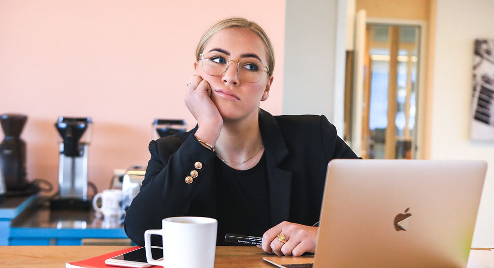 Upset young women with laptop and tablet  looking at camera at shop.