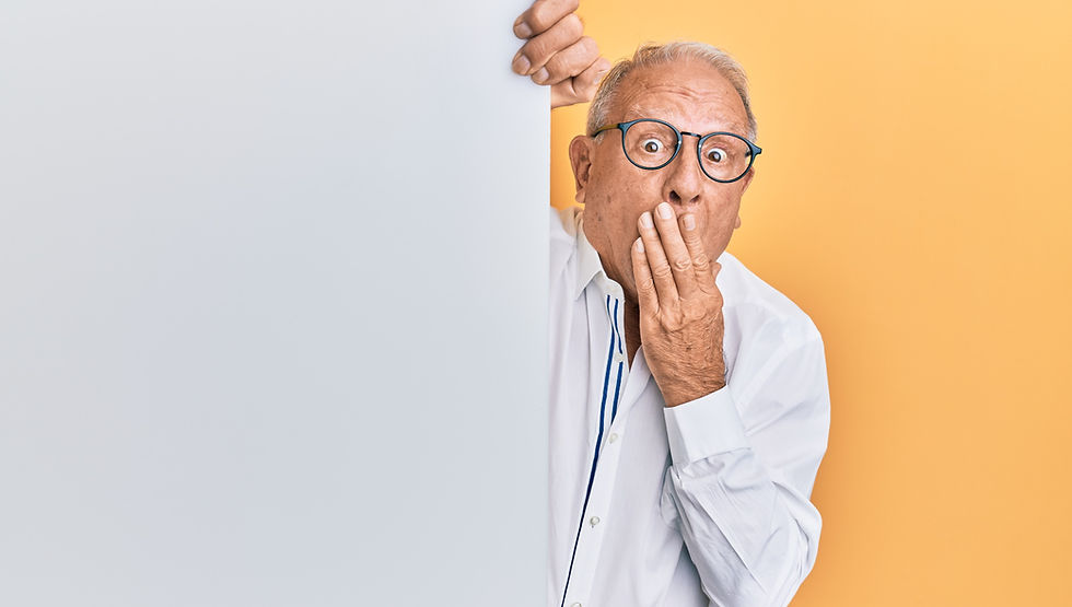 Old man doing "oops sign" with his hand over his mouth