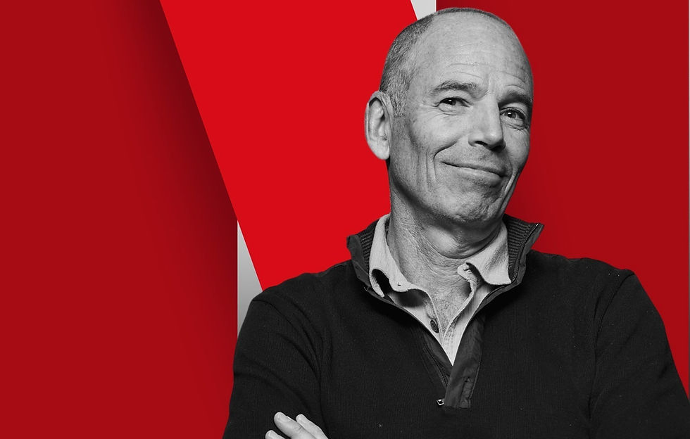 Marc Randolph infront of Netflix logo