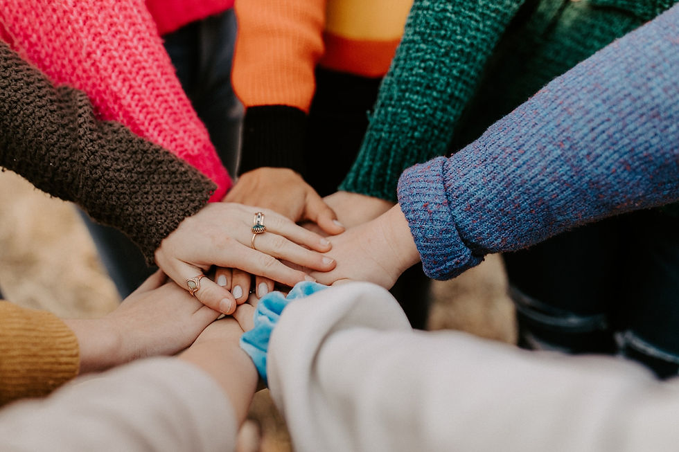 Group of people holding hands in a circle
